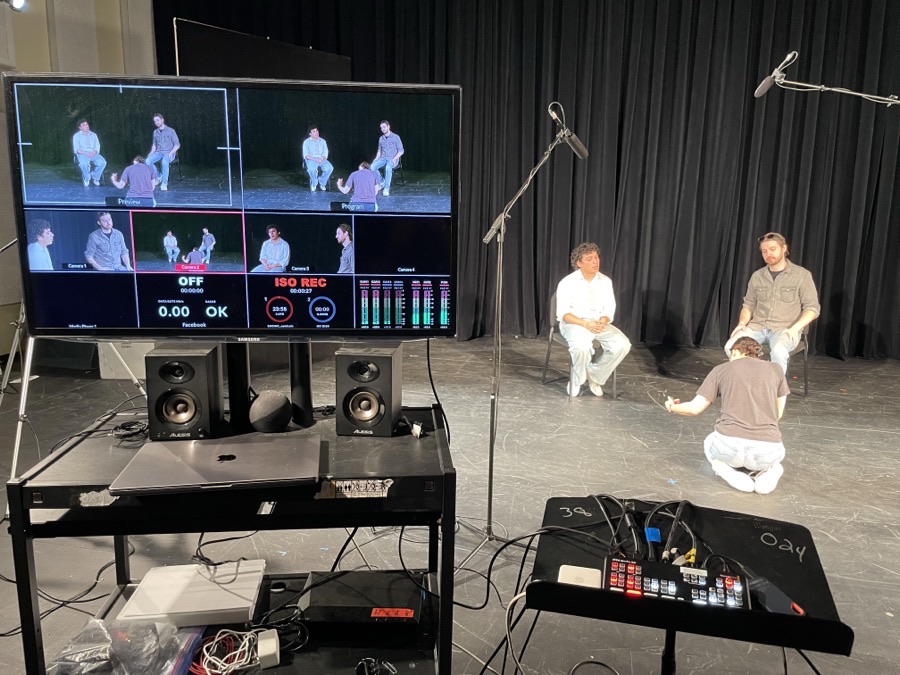 Multi-camera switcher monitor and crew filming an on-camera acting demonstration
