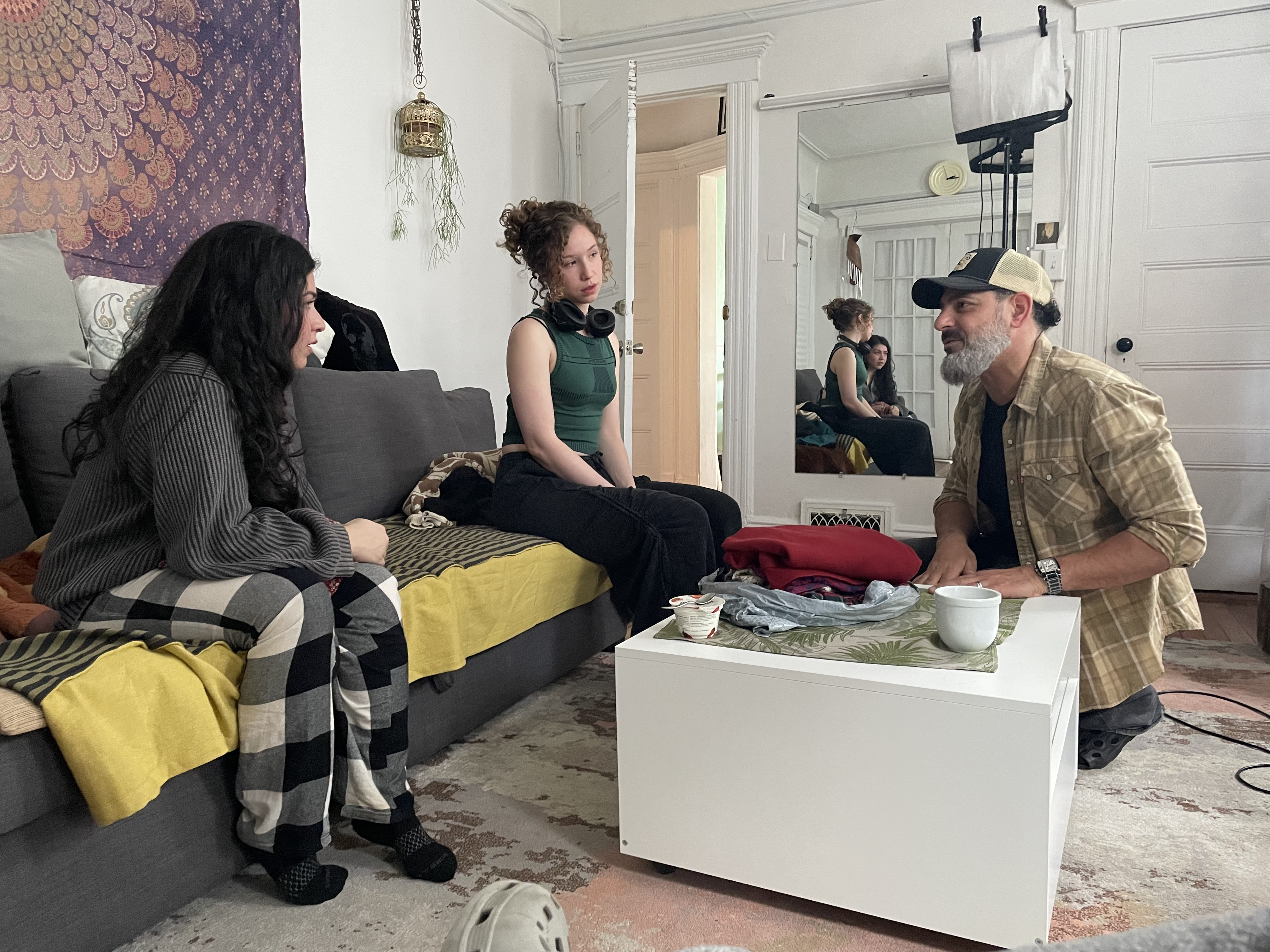Patrick directing two actors with mirror reflection on set