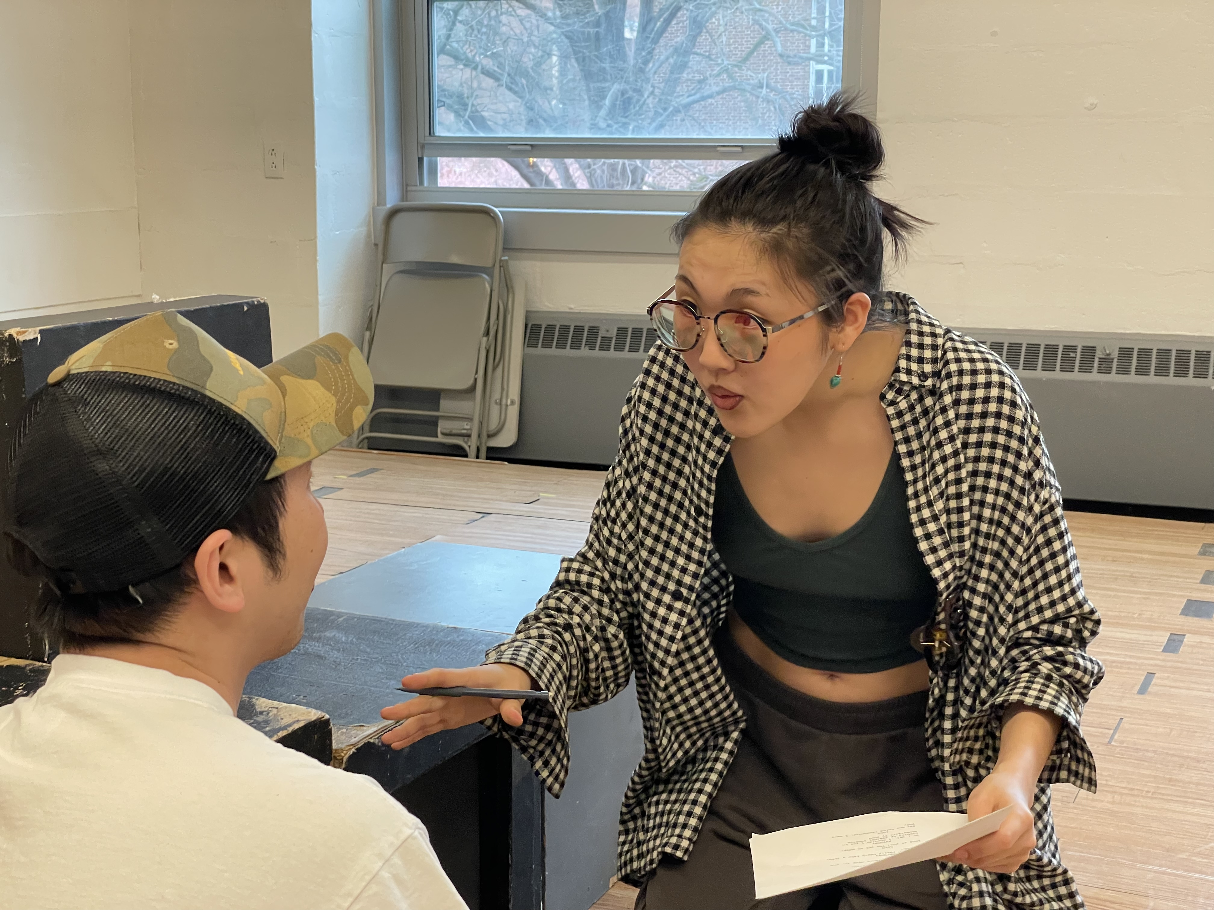 Actors in rehearsal working from script